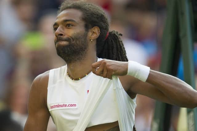 Dustin Brown touches his tattoo of his father after beating Nadal. Picture: Ian Rutherford