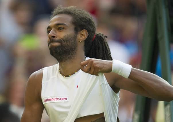 Dustin Brown touches his tattoo of his father after beating Nadal. Picture: Ian Rutherford