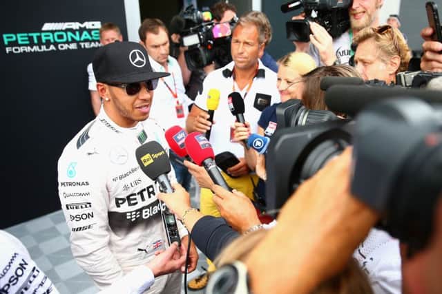 Lewis Hamilton addresses the media in the pits after practice at Silverstone yesterday. Picture: Getty