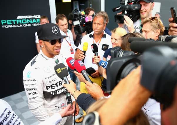 Lewis Hamilton addresses the media in the pits after practice at Silverstone yesterday. Picture: Getty