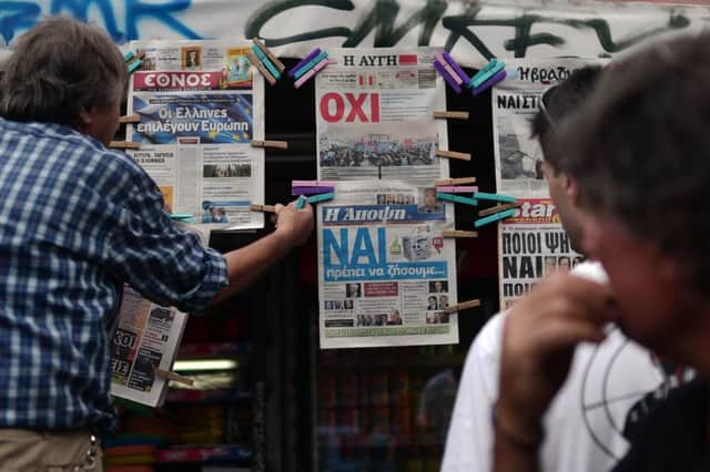 Newspaper headlines in Athens show support for both sides. Picture: AFP/Getty