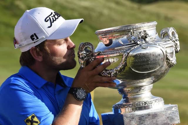 Austrias Bernd Wiesberger holds up his trophy after winning the 2015 Alstom Open de France at Guyancourt. Picture: AFP/Getty