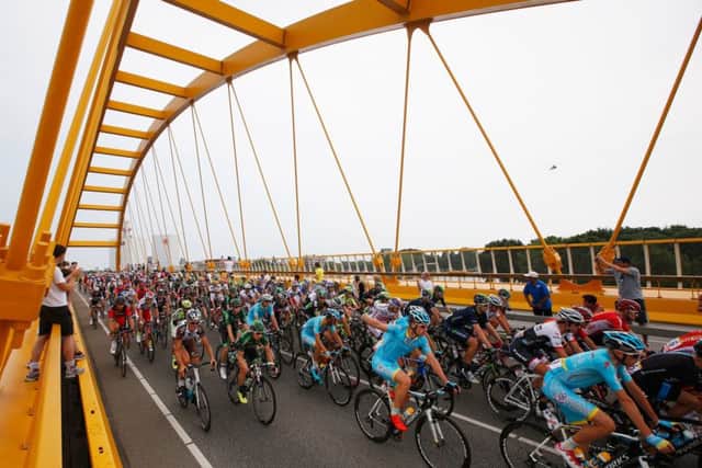 The peloton crosses a bridge during stage two of the Tour de France, a 166km stage between Utrecht and Zelande. Picture: Getty