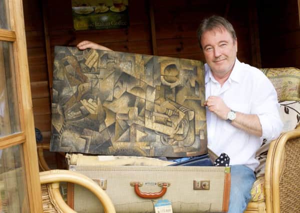 Dominic Currie with the hoax painting. Picture: Hemedia