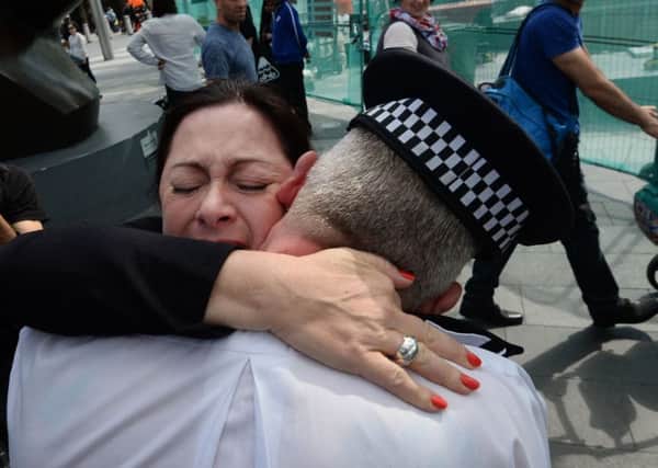 Gill Hicks hugs PC Andrew Maxwell yesterday. She lost both legs below the knee in the blast and he helped carry her to safety. Picture: PA