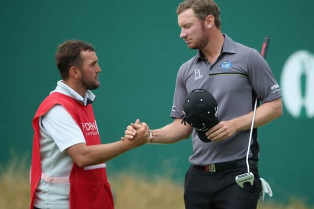 Chris Wood shakes hands with his caddie, Mark Crane, after his score of 65 equalled the course record during the final round of last years Open Championship at Royal Liverpool. Picture: Getty Images