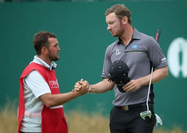 Chris Wood shakes hands with his caddie, Mark Crane, after his score of 65 equalled the course record during the final round of last years Open Championship at Royal Liverpool. Picture: Getty Images