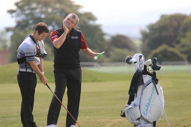 Paul Lawrie slaps on the sun screen before his practice round at Gullane yesterday.  Picture: Gordon Fraser