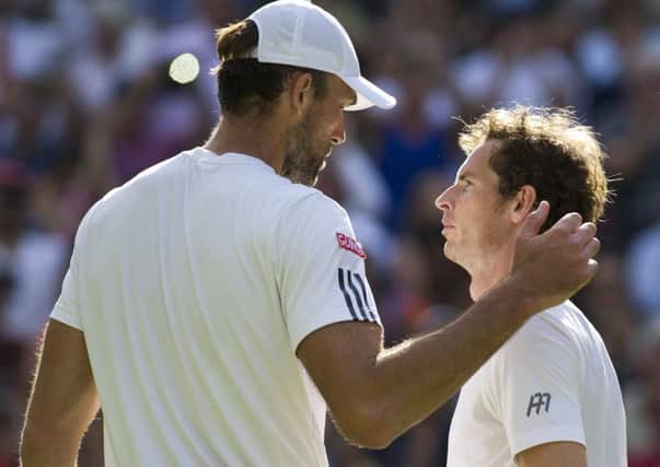 Andy Murray and Ivo Karlovic meet at the net after the Scot won their fourth-round match. Picture: Ian Rutherford