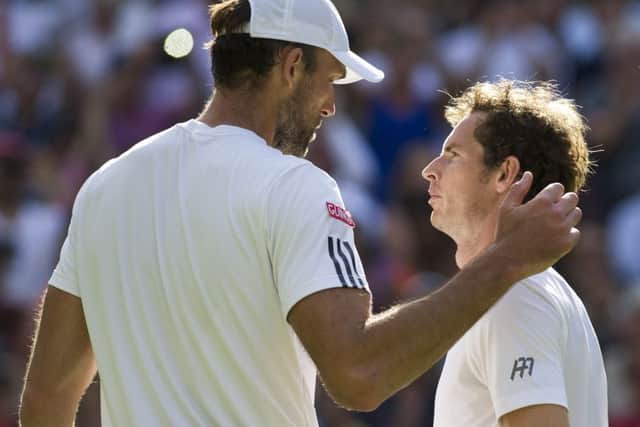 Andy Murray and Ivo Karlovic meet at the net after the Scot won their fourth-round match. Picture: Ian Rutherford