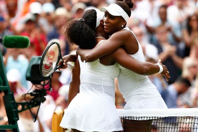 Serena, left, and Venus Williams hug after their fourth-round match. Picture: Getty