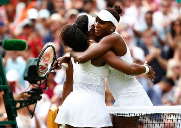 Serena, left, and Venus Williams hug after their fourth-round match. Picture: Getty