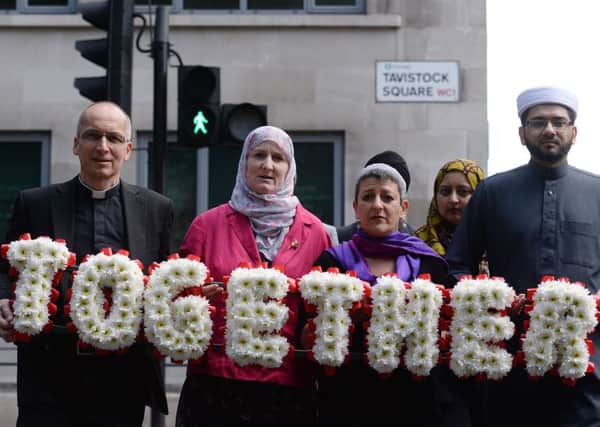 Faith leaders carry a floral tribute to Tavistock Square, London. Picture: PA