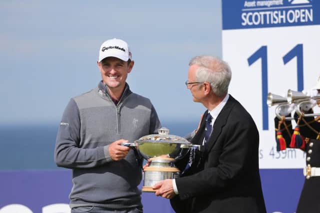 Defending champion Justin Rose, left, and Robert Dick with the Scottish Open trophy yesterday. Picture: Getty