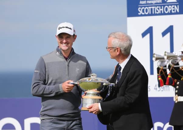 Defending champion Justin Rose, left, and Robert Dick with the Scottish Open trophy yesterday. Picture: Getty