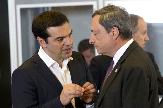 Greek PM Alexis Tsipras, left, speaks with ECB governor Mario Draghi. Picture: AP