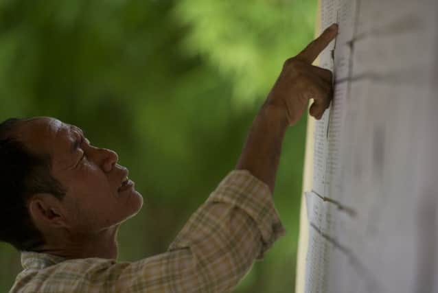 A man checks voter lists in the village of Wartheinkha, in Kawtmu township, about two hours from Rangoon. Picture: Getty