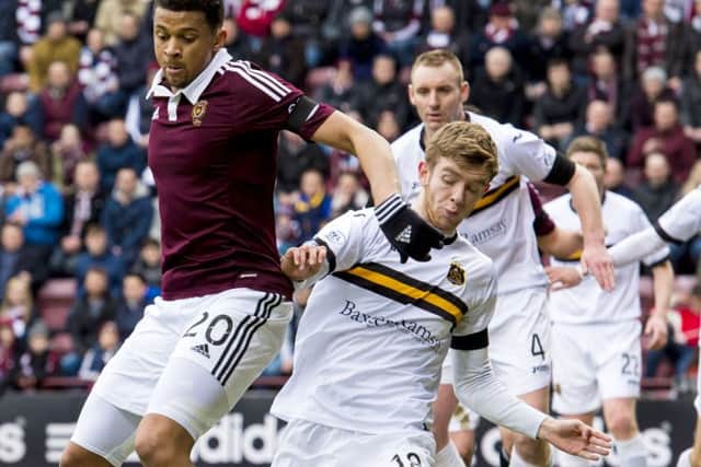 Findlay battles with Osman Sow during his loan spell with Dumbarton last season. Picture: SNS