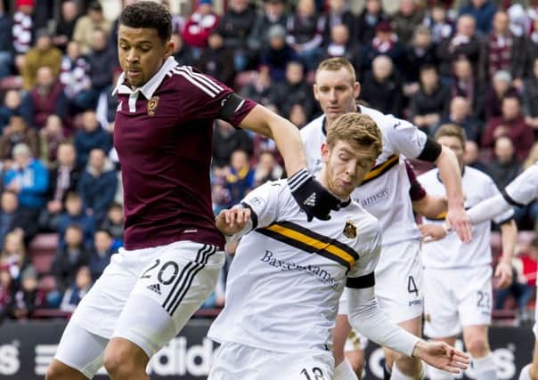 Findlay battles with Osman Sow during his loan spell with Dumbarton last season. Picture: SNS