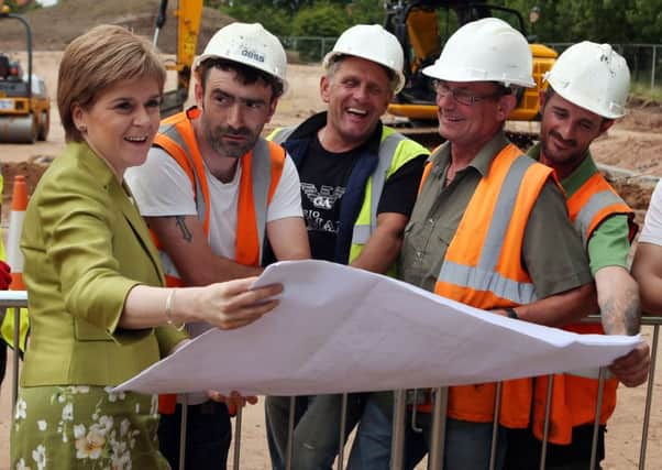 First Minister Nicola Sturgeon with workmen as she views plans to a new £4.4m unit at Intensive Psychiatric Care Unit (IPCU) at Stratheden Hospital in Cupar, Fife, on Monday. Picture: PA