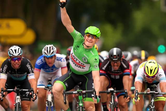 Andre Greipel raises his arm in triumph after crossing the line in Amiens to win stage five. Picture: Getty