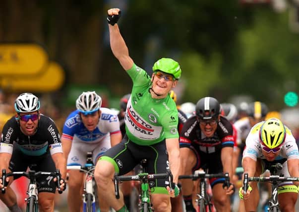 Andre Greipel raises his arm in triumph after crossing the line in Amiens to win stage five. Picture: Getty
