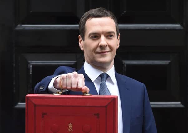 George Osborne holds his ministerial red box up to the media as he leaves 11 Downing Street. Picture: Getty