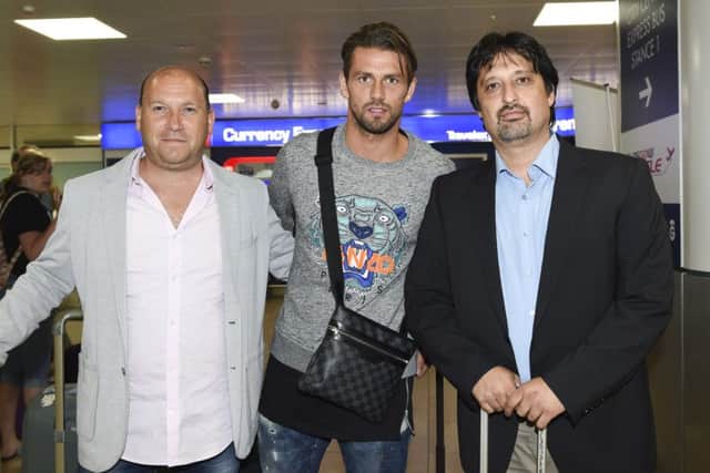 Logan Bailly, centre, arrives at Glasgow Airport ahead of holding talks with Celtic. Picture: SNS