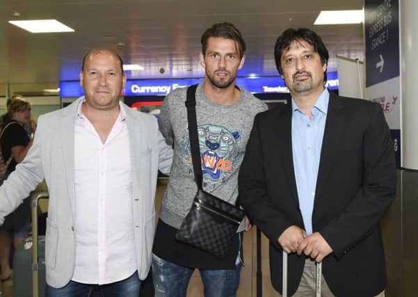 Logan Bailly, centre, arrives at Glasgow Airport ahead of holding talks with Celtic. Picture: SNS