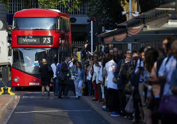 Early morning commuters form queues to board buses at Victoria station during the Tube strike. Picture: AFP/Getty
