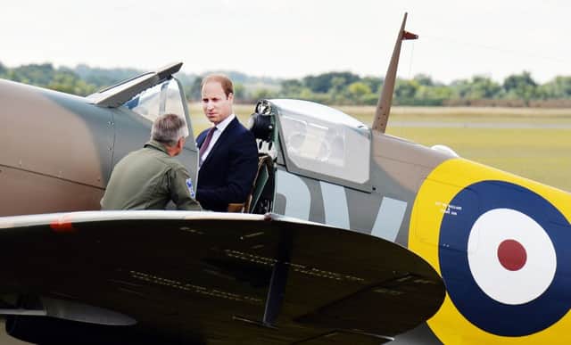 Prince William sits in a newly restored Spitfire at the Imperial War Museum in Duxford, near Cambridge yesterday. Picture: PA