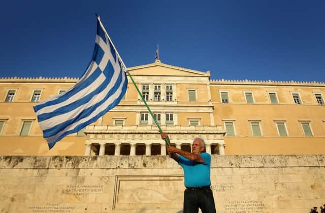 A protester outside the Greek parliament in Athens during a pro-European demonstration yesterday. Picture: Getty