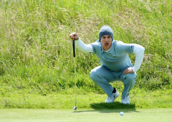 Thorbjorn Olesen lines up his putt on the 18th hole during the first round of the Scottish Open at Gullane. Picture: Getty
