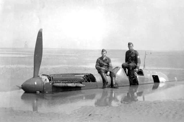 German soldiers pictured sitting on the fuselage of the downed Spitfire. Picture: PA