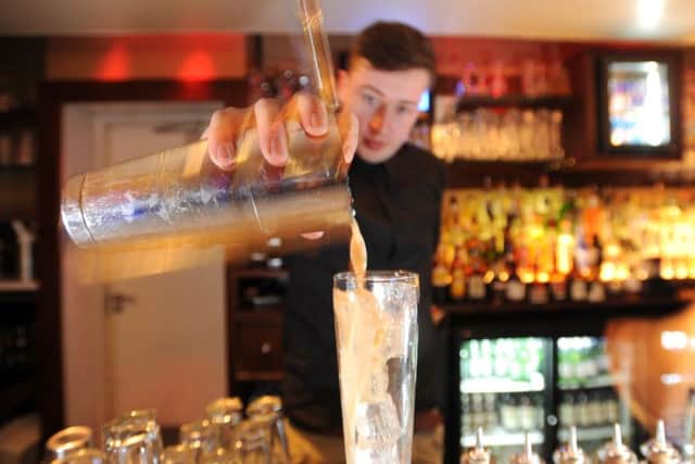 A bar tender serves a cocktail. The licensed trade is scared that higher salaries will add a punishing burden to an already embattled sector. Photograph: Jane Barlow