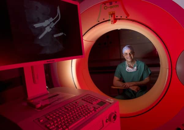 Neurosurgeon Mahmoud Kamel with Aberdeen Royal Infirmarys new spinal scanner. Picture: Derek Ironside