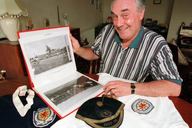 Jimmy Murray poses with his Scotland shirt, cap and a photograph of the goal - the countrys first ever at a World Cup finals . Pictures: SNS/Tina Norris