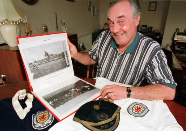 Jimmy Murray poses with his Scotland shirt, cap and a photograph of the goal - the countrys first ever at a World Cup finals . Pictures: SNS/Tina Norris