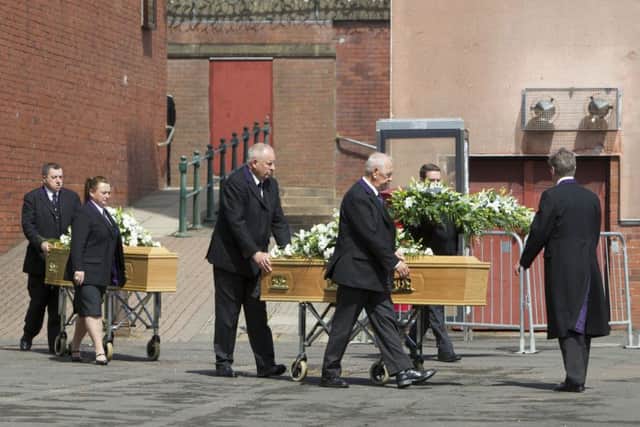 The coffins of Jim and Ann McQuire, who were killed in the Tunisian beach massacre, are taken from Abronhill Parish Church in Cumbernauld, Scotland. Picture: PA