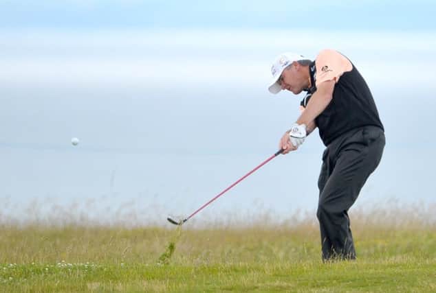 Leading Scot Paul Lawrie plays out of the rough on the 13th hole at Gullane yesterday. Picture: Jane Barlow