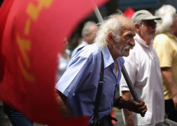 Anti-austerity demonstrators from the communist party take part in a minor rally through the streets of Athens. Picture: Getty Images