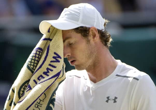 A dejected Andy Murray wipes his face with a towel. Picture: Ian Rutherford