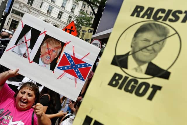 Protesters condemn Donald Trumps speech about Mexican immigrants outside the Trump International Hotel under construction in Washington DC. Picture: Getty