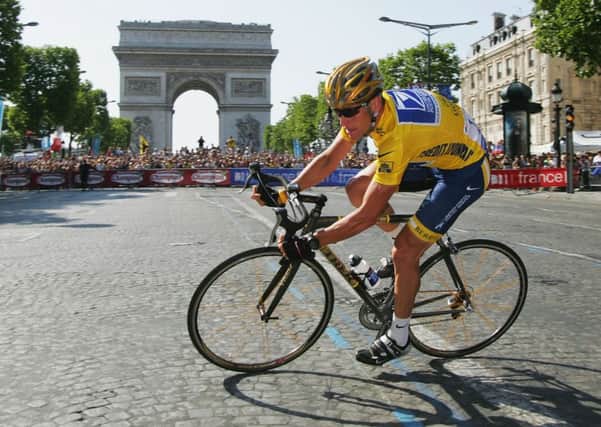 Lance Armstrong in Paris on his way to winning his sixth Tour. Armstrong returns to France for a charity ride this week. Picture: Getty