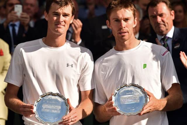 Jamie Murray (L) and Australia's John Peers (R) pose with their runners up plates after losing the men's doubles final. Picture: AFP/Getty Images
