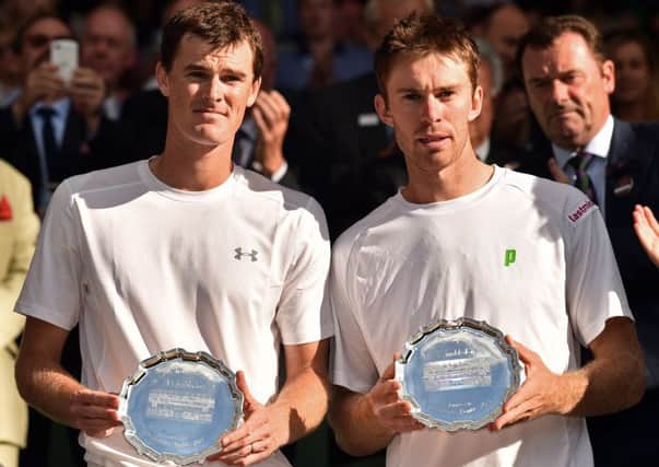 Jamie Murray (L) and Australia's John Peers (R) pose with their runners up plates after losing the men's doubles final. Picture: AFP/Getty Images