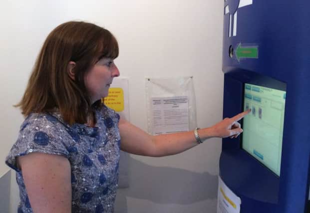 A woman tries out the services available in the pharmacy kiosk which is being trialled in Aberdeenshire. Picture: Contributed