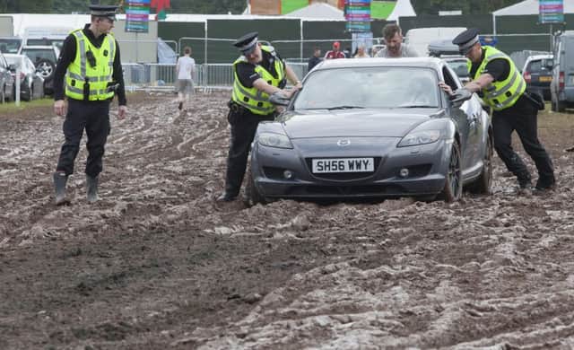 Police help one driver out of the quagmire. Picture: Hemedia