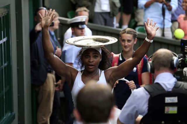 Serena Williams balances the Venus Rosewater Dish on her head after victory in the final on Saturday. Picture: PA