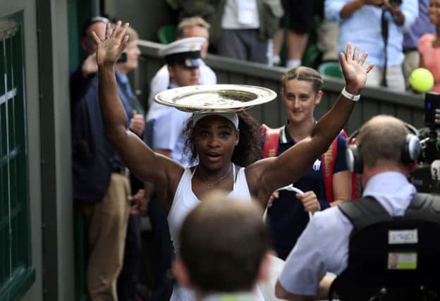 Serena Williams balances the Venus Rosewater Dish on her head after victory in the final on Saturday. Picture: PA